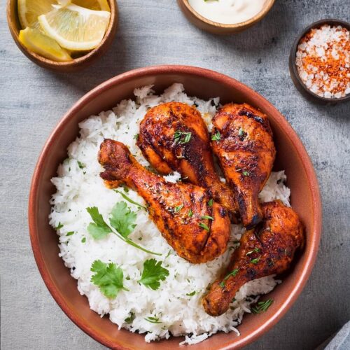 Bold and flavorful Tandoori Chicken, marinated in a blend of yogurt, garlic, ginger, and a vibrant mix of Indian spices. This juicy, oven-roasted or grilled chicken is known for its smoky char and signature bright red hue. Perfect for serving with basmati rice, naan, or a fresh cucumber salad, this dish delivers authentic Indian flavors that are both spicy and aromatic.