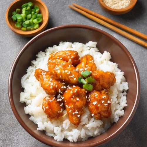 Crispy and tangy Chinese Orange Chicken featuring bite-sized chicken pieces, fried to golden perfection and coated in a sweet and zesty orange sauce. Infused with the flavors of fresh orange juice, garlic, and ginger, this takeout favorite is both delicious and easy to make at home. Serve with steamed rice or vegetables for a flavorful and satisfying meal that's perfect for any occasion