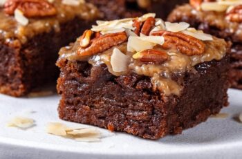 Rich and fudgy Chocolate Brownies with a delightful topping of toasted coconut and crunchy pecans. The combination of deep chocolate flavor, sweet coconut, and nutty pecans creates an irresistible texture and taste in every bite. Perfect for dessert or a sweet snack, these brownies are a delicious treat for any occasion.