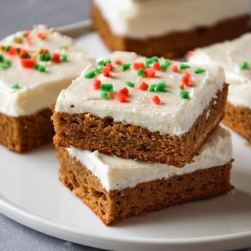 Soft and chewy Gingerbread Bars, filled with the warm, spicy flavors of cinnamon, ginger, and cloves. Topped with a sweet vanilla glaze that perfectly complements the rich molasses base, these bars bring the comforting taste of gingerbread in a simple, delicious form that’s perfect for the holidays.
