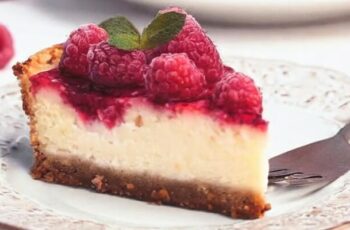 Embark on a culinary journey with our delectable Raspberry Cheesecake, a tantalizing dessert that marries the rich creaminess of cheesecake with the vibrant burst of fresh raspberries. Picture a buttery graham cracker crust cradling a velvety smooth cream cheese filling, perfectly blended with a hint of vanilla. The crowning glory is a luscious layer of raspberry compote, creating a harmonious balance of sweet and tangy flavors. Garnished with fresh raspberries and a dusting of powdered sugar, this Raspberry Cheesecake is not just a treat for the taste buds but a visual masterpiece that beckons you to indulge in its sumptuous layers.