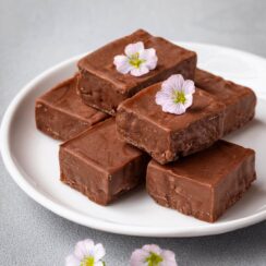 Decadent Chocolate Fudge Bar, featuring a rich, smooth chocolate fudge base topped with a layer of velvety ganache and sprinkled with a touch of sea salt. This indulgent treat offers a perfect balance of sweetness and intense chocolate flavor, with a creamy texture that melts in your mouth. Ideal for dessert or a sweet snack, these homemade fudge bars are a delightful way to satisfy your chocolate cravings.