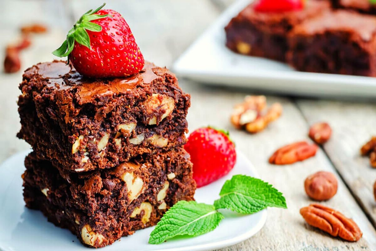 These walnut brownies are the perfect blend of fudgy and cakey – a little cakey around the edges and irresistibly fudgy in the center. Rich, chocolatey and stuffed with walnuts and chocolate chunks.