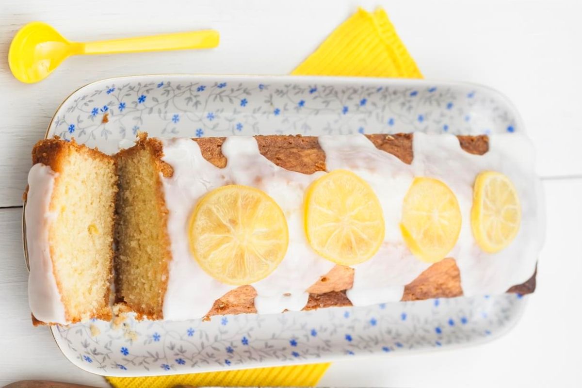 Lemon Cake With Icing – this is the perfect eggless and dairy-free lemon cake recipe! A soft, moist, simple-to-make and intensely lemon loaf cake soaked in tangy lemon syrup and topped with lemon glaze. This homemade lemon cake is sure to become a favorite!