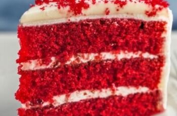 Experience the classic allure of Red Velvet Cake, perfect for any celebration. This iconic dessert features layers of moist, vibrant red cake with a subtle hint of cocoa, beautifully contrasted by a creamy, tangy cream cheese frosting. Each slice offers a perfect balance of sweetness and richness, with a velvety texture that melts in your mouth. Garnished with red cake crumbs and a touch of elegance, this homemade Red Velvet Cake is ideal for birthdays, holidays, or any special occasion.