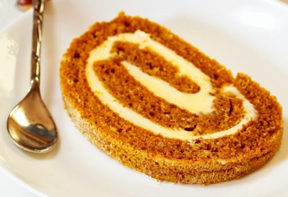 This classic Pumpkin Roll is a delightful fall dessert! It features a soft and tender pumpkin cake filled with creamy cream cheese, rolled, chilled, and sliced into an eye-catching dessert. In this guide, you'll discover everything you need to create this simple yet impressive, beautifully swirled treat!
