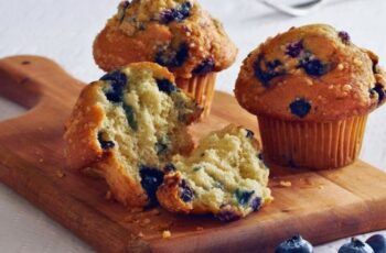 A blueberry muffin is a delectable baked pastry with a golden-brown exterior and a tender, moist crumb, generously studded with juicy blueberries that burst with flavor when you take a bite. Its sweet, slightly tart taste is complemented by a comforting aroma of warm vanilla and butter, making it a perfect breakfast or snack choice. Whether enjoyed warm from the oven or at room temperature, this classic treat is a timeless favorite, often paired with a steaming cup of coffee or a glass of milk, making it a delightful addition to any occasion.