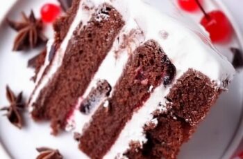 Indulge in the classic flavors of a Black Forest Cake, perfect for chocolate and cherry lovers. This decadent dessert features layers of moist chocolate sponge cake, generously filled with sweet cherries and fluffy whipped cream. Each layer is infused with a hint of cherry liqueur, adding depth and richness. Topped with chocolate shavings, whole cherries, and a light dusting of powdered sugar, this Black Forest Cake is an elegant treat for special occasions or any time you crave a slice of indulgence.