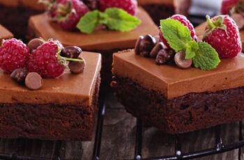 Decadent chocolate mousse brownies that redefine indulgence. These delightful treats feature a fudgy brownie base, its rich cocoa flavor enhanced by a layer of velvety chocolate mousse. The brownie is dense and chewy, providing a satisfying contrast to the airy and silky mousse topping. Each bite is a harmonious blend of deep chocolate notes, with the mousse adding a luxurious creaminess. Garnished with a sprinkle of cocoa powder or chocolate shavings, these brownies not only offer an exquisite taste experience but also a visually appealing dessert for any chocolate enthusiast.