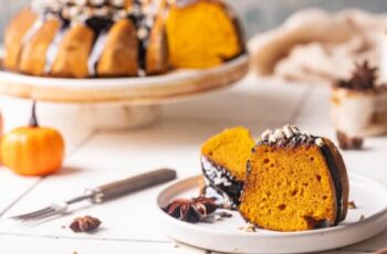 A stunning pumpkin bundt cake, embodying the warm and comforting essence of autumn. The cake's golden exterior hints at its moist and spiced interior, filled with the unmistakable aroma of pumpkin and fall spices. The bundt shape adds an elegant touch, making it a perfect centerpiece for seasonal gatherings. Each slice reveals a tender crumb, delicately flavored with cinnamon, nutmeg, and cloves, creating a symphony of autumnal flavors. Glazed with a luscious cream cheese icing or a drizzle of maple glaze, this pumpkin bundt cake is a delectable celebration of the harvest season, capturing the essence of cozy gatherings and festive warmth.