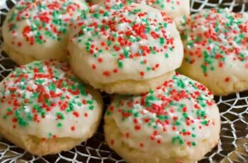 Delightful Italian Ricotta Cookies, small treats with a cake-like texture that melt in your mouth. These cookies are enriched with creamy ricotta cheese, offering a moist and tender crumb. Flavored with hints of vanilla or almond extract, they provide a subtle sweetness that makes them a delightful choice for any occasion. Each cookie is typically topped with a smooth glaze, which adds a touch of sweetness and a glossy finish. You can customize the glaze with lemon or orange zest to enhance the citrus notes. The cookies are often adorned with colorful sprinkles or nonpareils, adding a festive and visually appealing touch. Italian Ricotta Cookies are a charming addition to dessert tables, perfect for sharing during holidays, celebrations, or as a sweet treat with a cup of coffee or tea.