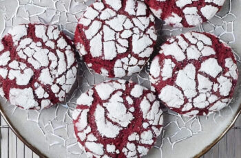 Irresistible red velvet cookies that capture the essence of the classic cake in bite-sized form. These vibrant treats showcase a deep red hue, offering a hint of cocoa and a touch of buttermilk for that signature red velvet flavor. Studded with white chocolate chips or chunks, each cookie provides a delightful contrast of textures—soft and chewy on the inside with a slightly crisp edge. The aroma is a tempting mix of sweet vanilla and subtle cocoa notes. To enhance their visual appeal, a dusting of powdered sugar or a drizzle of cream cheese icing can be added. These red velvet cookies are a perfect way to enjoy the iconic flavors of red velvet in a portable and shareable form, making them a delightful addition to any cookie jar or dessert table.