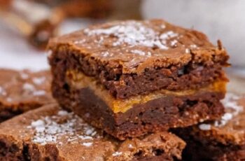 Experience the ultimate indulgence with our Caramel Stuffed Brownies. Imagine a fudgy and decadent brownie base, each square concealing a gooey pocket of rich caramel that oozes delightfully with every bite. The chocolatey exterior gives way to a luscious, sweet surprise, creating a perfect balance of textures and flavors. Topped with a sprinkle of sea salt to enhance the richness, these Caramel Stuffed Brownies are a heavenly treat for those who appreciate the perfect marriage of chocolate and caramel. Whether served as a dessert centerpiece or shared among friends, these brownies are a delightful symphony of sweetness.
