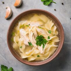 Comforting and rich Creamy Chicken Noodle Soup made with tender chicken, hearty egg noodles, and fresh vegetables simmered in a velvety, flavorful broth. This cozy, homemade soup is seasoned with garlic, herbs, and a hint of cream, creating a perfect blend of savory and creamy textures. Ideal for chilly days or a quick weeknight dinner, this soup is a family favorite that's both satisfying and nourishing