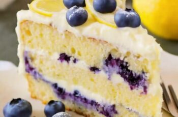 Indulge in the bright and refreshing flavors of our Lemon Blueberry Cake. Picture a light and airy lemon-infused cake, layered with a generous spread of velvety lemon cream cheese frosting. Scattered throughout are plump, juicy blueberries, adding bursts of sweetness and a delightful contrast in texture. The cake is beautifully garnished with lemon zest and a handful of fresh blueberries, creating a visually stunning and mouthwatering dessert. Whether you're celebrating a special occasion or simply treating yourself, this Lemon Blueberry Cake is a symphony of citrusy and fruity perfection that will leave your taste buds dancing with joy.