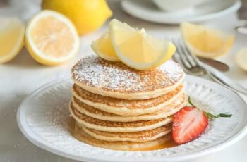 Delicious and fluffy Lemon Pancakes that add a burst of citrusy brightness to your breakfast. These pancakes are a delightful way to start your day, offering a perfect balance of sweet and tangy flavors. The pancake batter is typically made with flour, sugar, baking powder, eggs, and milk. The addition of fresh lemon zest or lemon juice infuses the batter with the refreshing essence of lemon. Some recipes may also include a touch of vanilla extract for added depth of flavor. Once cooked on a griddle or skillet, these pancakes can be served with a variety of toppings to enhance the lemony goodness. Common choices include a drizzle of maple syrup, a dollop of whipped cream, or a sprinkle of powdered sugar. Fresh berries or a lemon glaze can also be delightful additions. Lemon Pancakes are a delightful and uplifting twist on classic pancakes, bringing a touch of sunshine to your breakfast table.