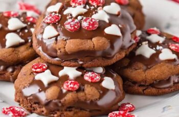 Delicious Peppermint Hot Chocolate Cookies that capture the cozy flavors of a classic winter beverage. These cookies are a delightful fusion of rich chocolate and refreshing peppermint, making them a perfect treat for the holiday season. The cookie dough is typically infused with cocoa powder for a deep chocolatey flavor. Crushed peppermint candies or peppermint extract is added to provide the invigorating peppermint twist. To enhance the texture, chocolate chips or chunks are often mixed into the dough. Once baked to perfection, these cookies are sometimes adorned with a drizzle of white chocolate, a sprinkle of crushed candy canes, or a dusting of powdered sugar. This not only adds a festive touch but also enhances the overall sweetness and visual appeal. Peppermint Hot Chocolate Cookies are a delightful addition to holiday cookie trays or a cozy evening by the fireplace with a cup of hot cocoa. They embody the warmth and joy of the winter season.