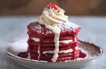 Scrumptious Red Velvet Pancakes that bring the classic flavors of red velvet cake to your breakfast table. These pancakes boast a rich cocoa flavor with a hint of tanginess, creating a delightful combination of sweetness and depth. The batter is typically made with flour, cocoa powder, buttermilk, eggs, sugar, and a touch of red food coloring to achieve that iconic red hue. Baking powder or baking soda may be added to ensure fluffy pancakes. Once cooked to perfection on a griddle or skillet, these red velvet pancakes can be served with a variety of toppings. Cream cheese frosting, whipped cream, fresh berries, or a dusting of powdered sugar are popular choices to enhance both the flavor and presentation. Perfect for a special breakfast or brunch occasion, Red Velvet Pancakes offer a festive and delicious way to start your day.