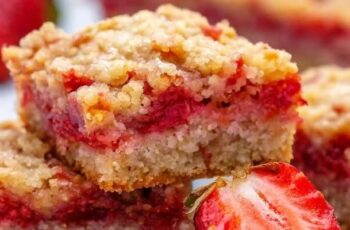 Experience the delightful fusion of sweetness and texture with our Strawberry Oatmeal Crumble Bars. Imagine a golden-brown, buttery oatmeal crust providing a hearty base. Layered on top is a luscious strawberry filling, bursting with the natural sweetness of ripe strawberries. The crowning glory is a crumbly oatmeal topping, adding a delightful crunch to each bite. These bars are a perfect marriage of flavors and textures, with the sweetness of strawberries complemented by the wholesome goodness of oats. Adorned with a dusting of powdered sugar, these Strawberry Oatmeal Crumble Bars are a visual and culinary treat for any occasion.