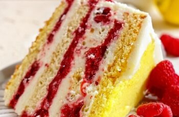 Transport yourself to a realm of citrusy bliss with our Lemon Raspberry Cake. Imagine layers of moist lemon-infused sponge cake, delicately balanced with tart raspberry filling. Each slice offers a symphony of flavors, where zesty lemon meets the vibrant sweetness of raspberries. The cake is elegantly adorned with a creamy lemon frosting, beautifully finished with fresh raspberries on top. Whether you're celebrating a special occasion or simply craving a burst of refreshing flavors, this Lemon Raspberry Cake is a perfect harmony of tangy and sweet indulgence