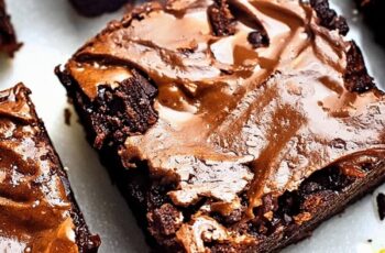 Discover the ultimate indulgence with our Best Brownies Recipe, delivering rich, fudgy perfection in every bite. Imagine thick, decadent brownies with a crackly top, made from high-quality cocoa powder and melted chocolate for an intense chocolate flavor. These brownies boast a moist, gooey center with a slightly crisp edge, offering a delightful contrast in texture. Whether you prefer them plain or studded with walnuts or chocolate chips, these homemade brownies are sure to satisfy any chocolate lover's craving. Perfect for any occasion, from casual snacking to elegant desserts, our Best Brownies Recipe is easy to follow and yields consistently delicious results.