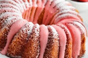 Delight in the sweet and fruity flavors of a homemade strawberry Bundt cake. This moist and tender cake is infused with fresh strawberry puree, giving it a vibrant pink hue and natural sweetness. Baked to perfection in a classic Bundt pan, it features a beautiful shape and a light, airy texture. Topped with a drizzle of creamy strawberry glaze and garnished with fresh strawberry slices, this cake is perfect for special occasions, afternoon tea, or a delightful treat any time of the year.
