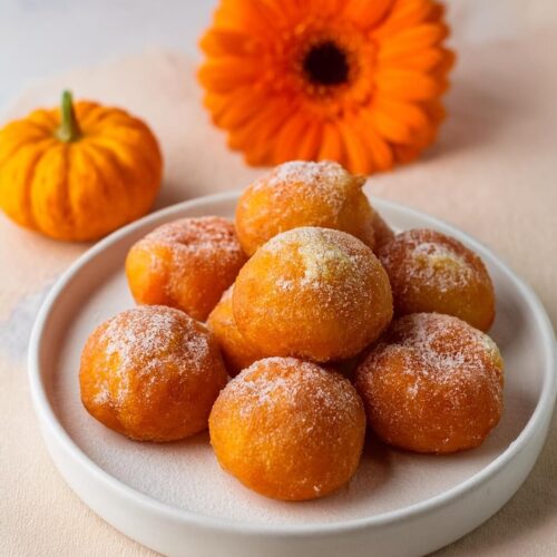 Soft and fluffy Mini Pumpkin Donuts packed with warm pumpkin spice flavors and coated in a sweet cinnamon sugar topping. These bite-sized treats are made with real pumpkin puree and a blend of spices, creating the perfect balance of sweetness and spice. Perfect for fall gatherings, breakfast, or a cozy snack, these donuts are both irresistible and easy to make.