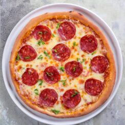 Whenever you're in the mood for a classic comfort food, this Pepperoni Pizza delivers with its crispy crust, zesty tomato sauce, gooey cheese, and spicy pepperoni slices. It's a timeless favorite that's perfect for a casual night in or sharing with friends and family!