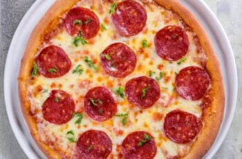 Whenever you're in the mood for a classic comfort food, this Pepperoni Pizza delivers with its crispy crust, zesty tomato sauce, gooey cheese, and spicy pepperoni slices. It's a timeless favorite that's perfect for a casual night in or sharing with friends and family!