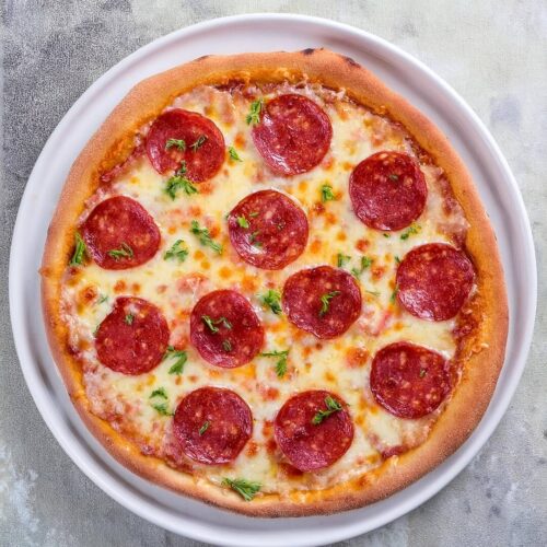 Whenever you're in the mood for a classic comfort food, this Pepperoni Pizza delivers with its crispy crust, zesty tomato sauce, gooey cheese, and spicy pepperoni slices. It's a timeless favorite that's perfect for a casual night in or sharing with friends and family!