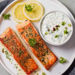 Perfectly pan-seared Salmon with a tangy Lemon Yogurt Sauce, featuring a rich, flaky fillet paired with a creamy sauce made from Greek yogurt, fresh lemon juice, garlic, and herbs. This healthy and flavorful dish is a delightful blend of bright, zesty flavors and savory salmon, making it ideal for a light dinner or special occasion. Serve with roasted vegetables or a fresh salad for a complete, nutritious meal.