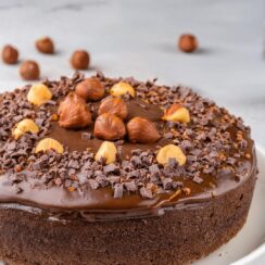 This Chocolate Hazelnut Cake is a decadent treat that combines the rich flavors of chocolate and the nutty goodness of hazelnuts! The moist, tender cake is infused with layers of chocolate and finely ground hazelnuts, creating a perfect balance of sweetness and depth. Topped with a smooth, velvety chocolate ganache and a sprinkle of crunchy hazelnuts, each bite is a luxurious experience. Perfect for special occasions or when you want to indulge, this cake is sure to impress with its rich flavor and beautiful presentation.
