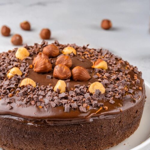 This Chocolate Hazelnut Cake is a decadent treat that combines the rich flavors of chocolate and the nutty goodness of hazelnuts! The moist, tender cake is infused with layers of chocolate and finely ground hazelnuts, creating a perfect balance of sweetness and depth. Topped with a smooth, velvety chocolate ganache and a sprinkle of crunchy hazelnuts, each bite is a luxurious experience. Perfect for special occasions or when you want to indulge, this cake is sure to impress with its rich flavor and beautiful presentation.
