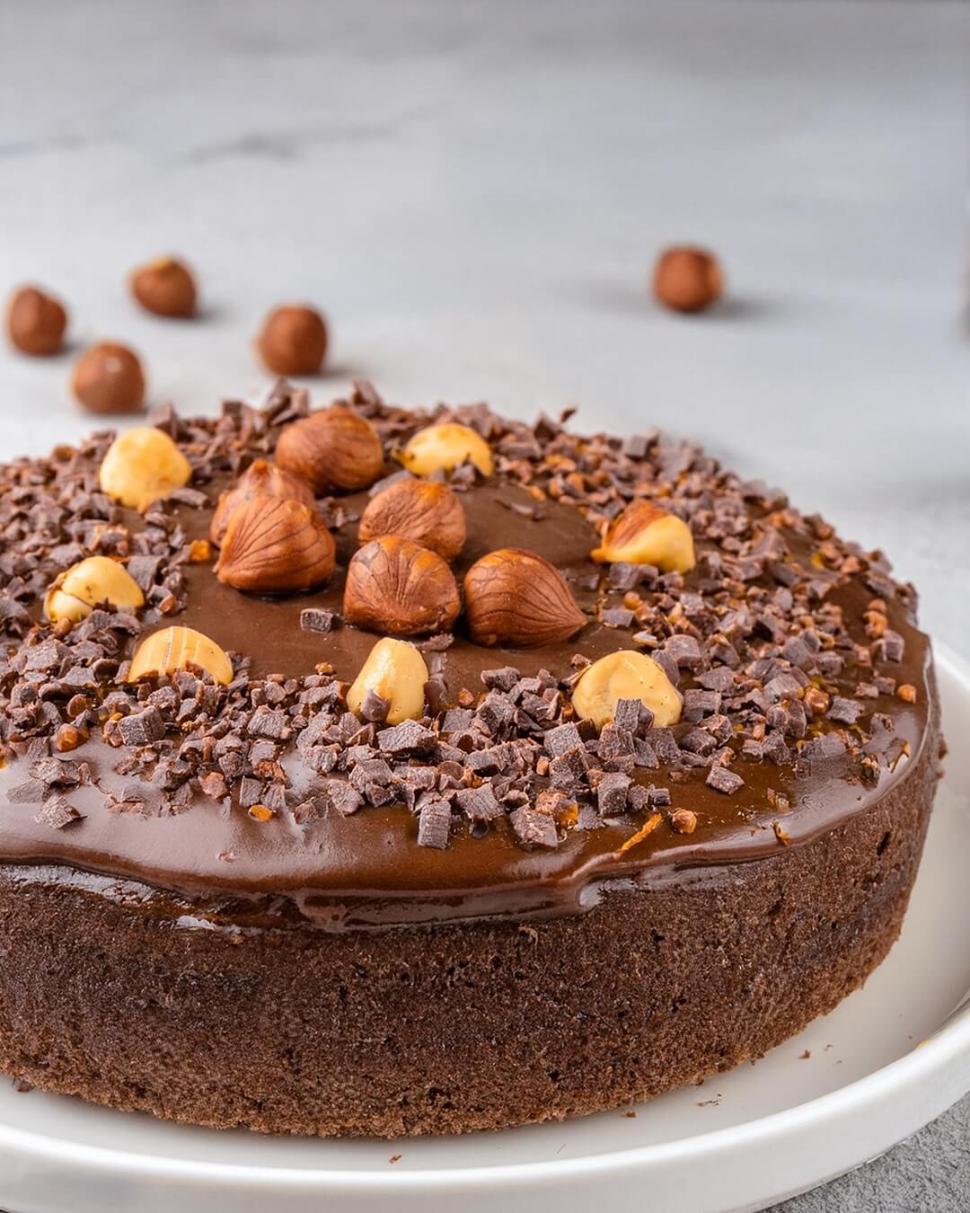 This Chocolate Hazelnut Cake is a decadent treat that combines the rich flavors of chocolate and the nutty goodness of hazelnuts! The moist, tender cake is infused with layers of chocolate and finely ground hazelnuts, creating a perfect balance of sweetness and depth. Topped with a smooth, velvety chocolate ganache and a sprinkle of crunchy hazelnuts, each bite is a luxurious experience. Perfect for special occasions or when you want to indulge, this cake is sure to impress with its rich flavor and beautiful presentation.