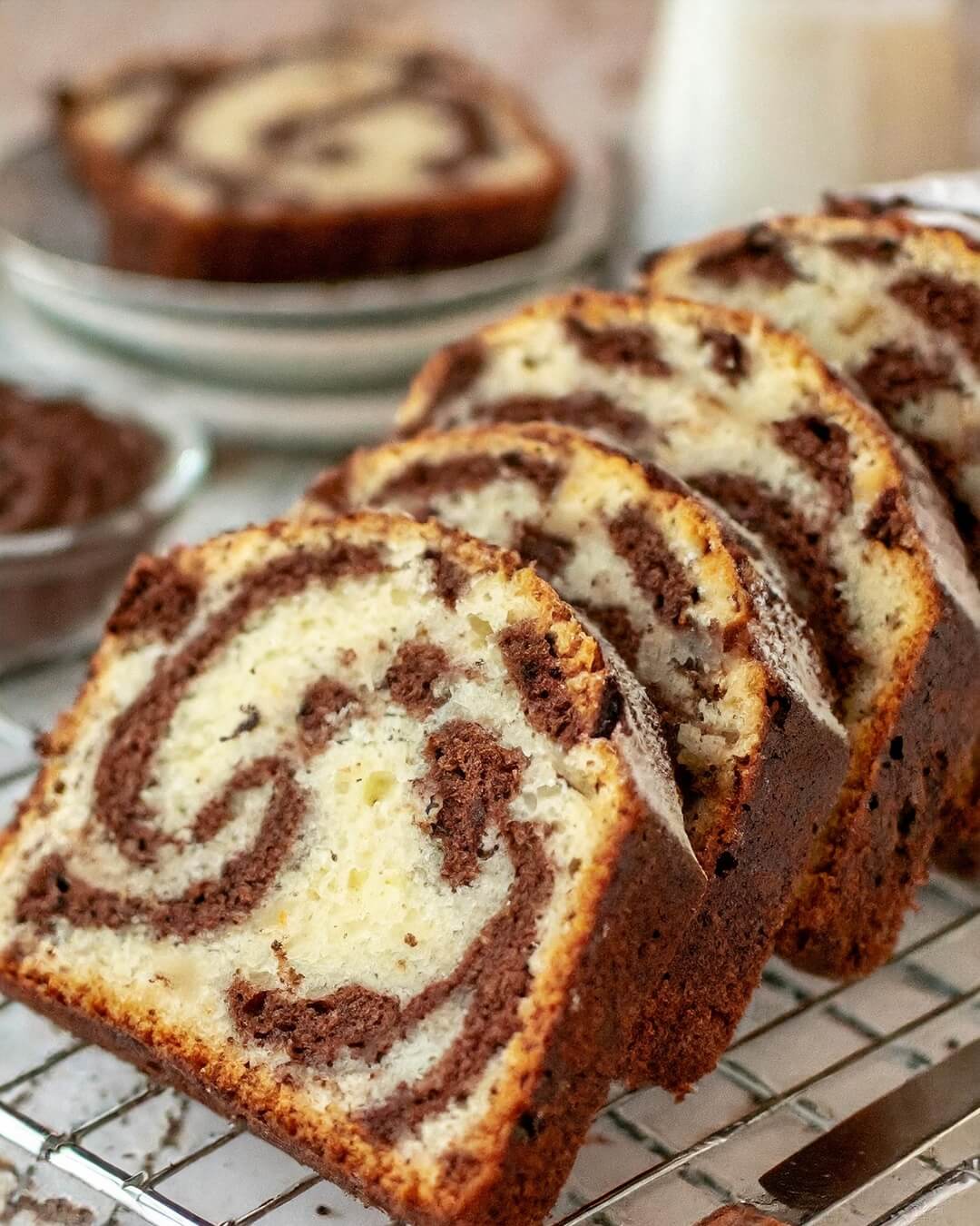 This Chocolate Marble Loaf Cake is a timeless treat suitable for afternoon tea, breakfast, or dessert. The cake, featuring a classic combination of half vanilla and half chocolate, made with yogurt, evokes nostalgic memories of a childhood favorite that you never grow tired of enjoying!