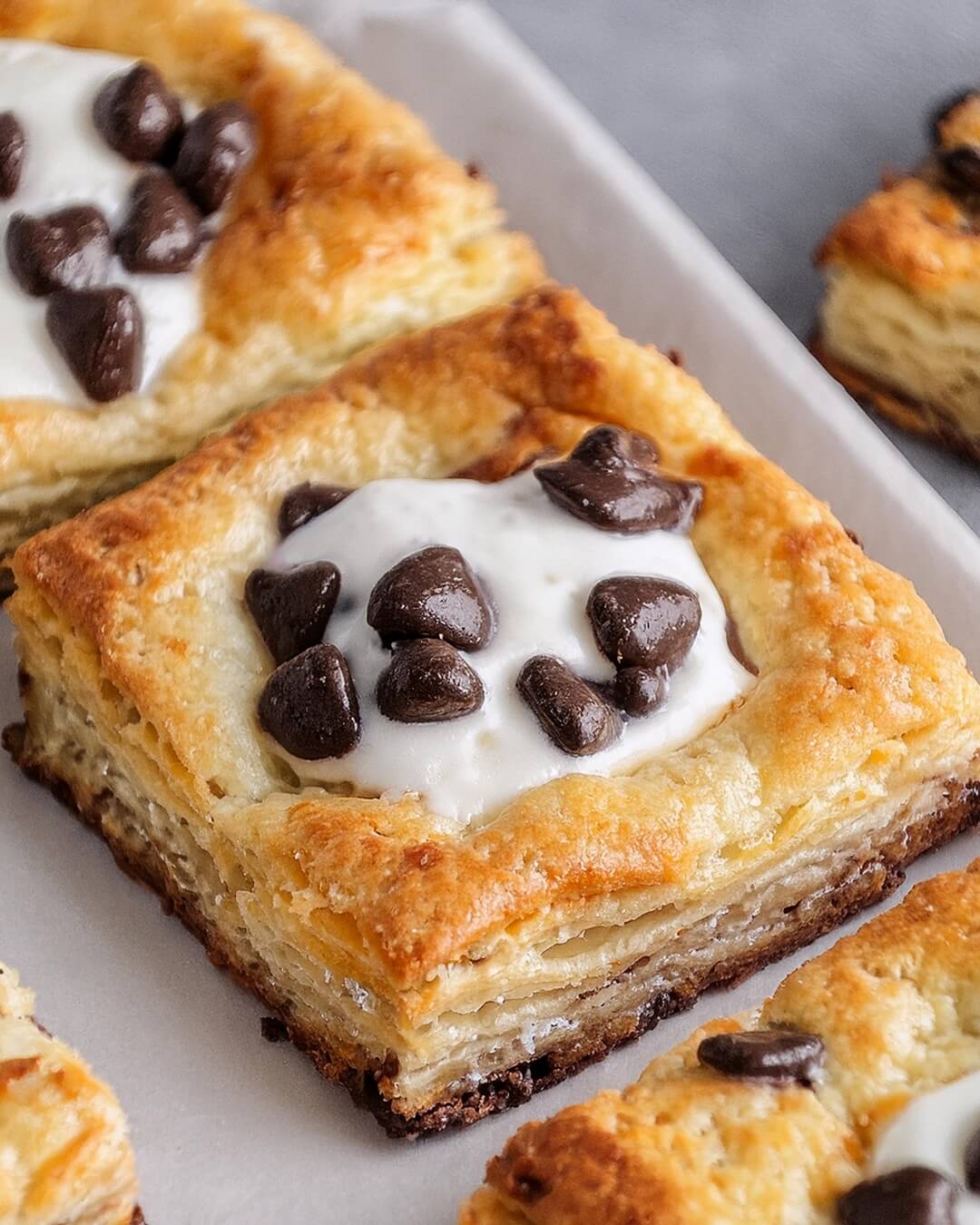 These Ricotta Chocolate Chip Pastries are a delightful mix of creamy, sweet ricotta and decadent chocolate chips wrapped in flaky pastry! The filling, made with smooth ricotta and mini chocolate chips, is lightly sweetened and nestled inside layers of buttery, golden pastry that bakes to perfection. Each bite offers a balance of creamy, rich filling and crisp pastry, making them perfect for breakfast, dessert, or a sweet snack.