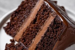 This Triple Layer Chocolate Cake is the ultimate treat for chocolate lovers! Three moist, rich layers of decadent chocolate cake are stacked high, each one filled with creamy, velvety chocolate frosting. The cake is then generously frosted with more luscious chocolate, creating a stunning, indulgent dessert that’s perfect for any celebration. Whether it’s a special occasion or a sweet indulgence, each bite is a pure, chocolatey dream with just the right balance of sweetness and richness.