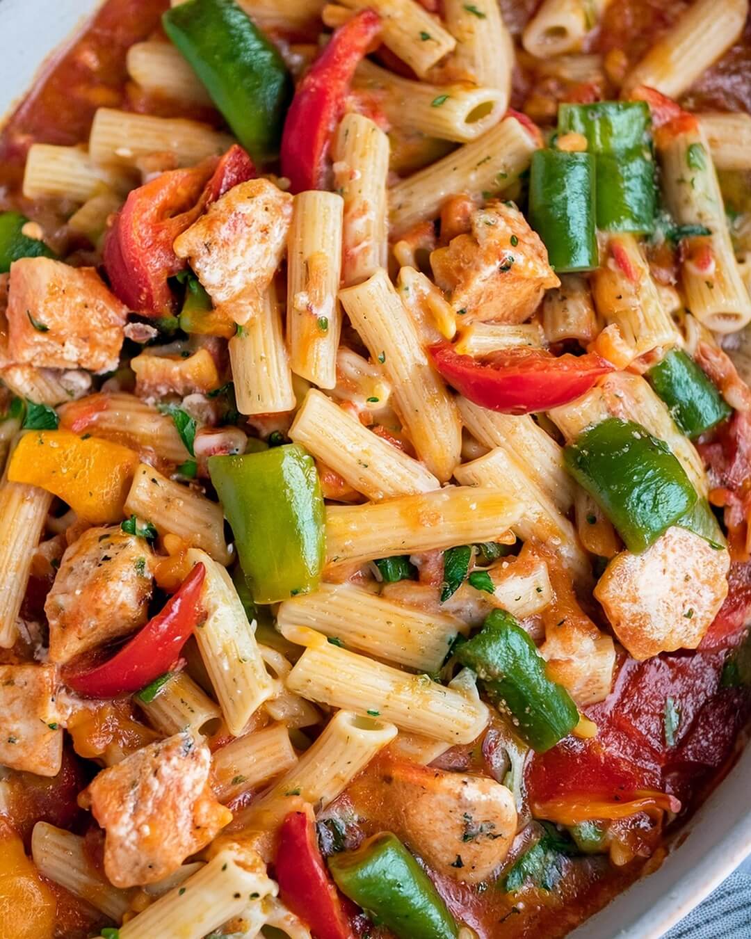 Cajun Chicken Pasta is a vibrant and flavorful dish with tender chicken, smoky chorizo, and a creamy Cajun-spiced sauce. Bell peppers and spinach add texture and color, while fresh cherry tomatoes brighten up the dish. Topped with melted cheddar and fresh parsley, this dish is a hearty, satisfying meal that's sure to please.