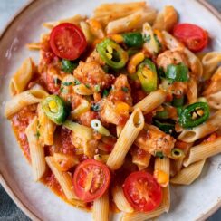 Cajun Chicken Pasta is a vibrant and flavorful dish with tender chicken, smoky chorizo, and a creamy Cajun-spiced sauce. Bell peppers and spinach add texture and color, while fresh cherry tomatoes brighten up the dish. Topped with melted cheddar and fresh parsley, this dish is a hearty, satisfying meal that's sure to please.