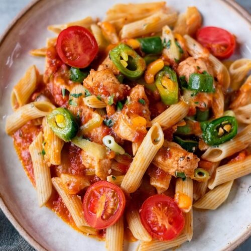 Cajun Chicken Pasta is a vibrant and flavorful dish with tender chicken, smoky chorizo, and a creamy Cajun-spiced sauce. Bell peppers and spinach add texture and color, while fresh cherry tomatoes brighten up the dish. Topped with melted cheddar and fresh parsley, this dish is a hearty, satisfying meal that's sure to please.