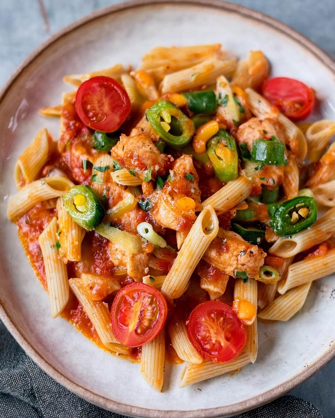 Cajun Chicken Pasta is a vibrant and flavorful dish with tender chicken, smoky chorizo, and a creamy Cajun-spiced sauce. Bell peppers and spinach add texture and color, while fresh cherry tomatoes brighten up the dish. Topped with melted cheddar and fresh parsley, this dish is a hearty, satisfying meal that's sure to please.
