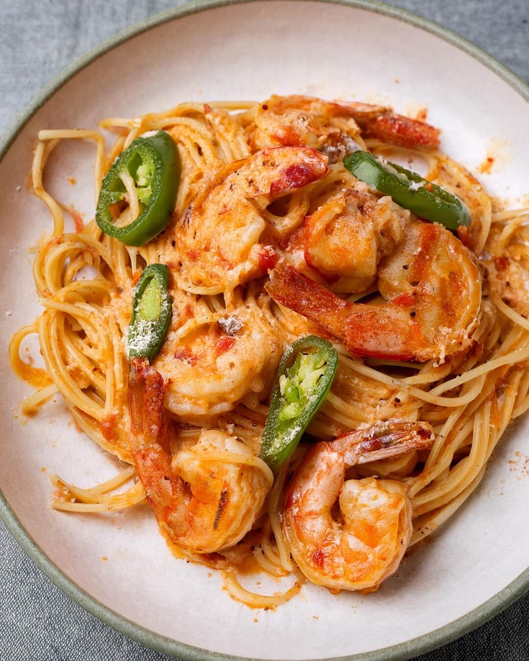 Cajun Prawn Pasta combines tender, spiced prawns with a creamy Cajun sauce packed with bold flavors from hot sauce, Worcestershire, and a touch of vinegar. Sweet bell pepper, spicy jalapeño, and garlic provide balance and depth, while parmesan adds richness. Served over linguine and garnished with fresh parsley, this dish is a spicy, creamy delight perfect for any pasta lover.