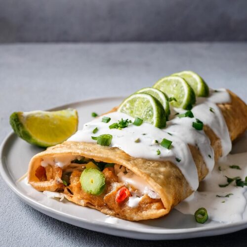 These Chicken Chimichangas are a crispy, golden delight packed with a flavorful chicken and refried bean filling, infused with spices and gooey cheese. Serve them topped with sour cream, guacamole, and diced tomatoes for a satisfying, restaurant-style dish.