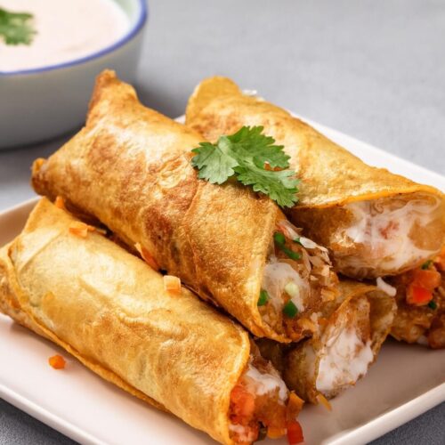 These Chicken Flautas are crispy, golden rolls filled with seasoned chicken, melted cheese, and mild green chiles. Serve them with sour cream, guacamole, pico de gallo, and salsa for a complete meal full of flavors and textures—perfect for snacking or as an appetizer!