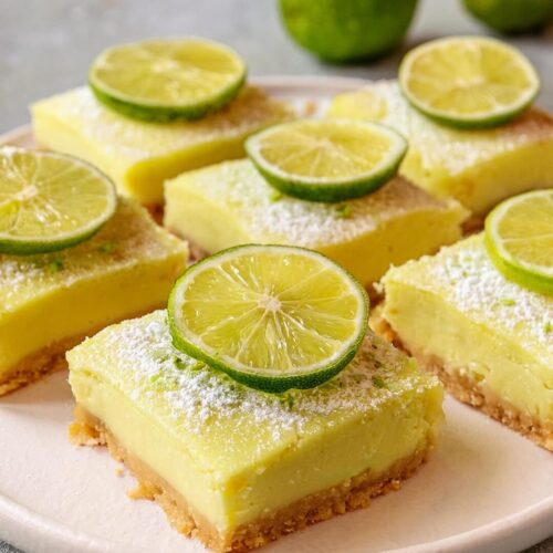 These Lime Bars feature a buttery almond shortbread crust topped with a zesty lime custard filling. The contrast between the nutty base and tangy lime is perfect for a refreshing treat with a hint of sweetness and a touch of vibrant green.