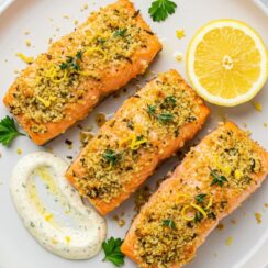 Parmesan Crusted Salmon with Roasted Broccoli features succulent salmon with a golden, cheesy crust infused with lemon, thyme, and fresh parsley.
