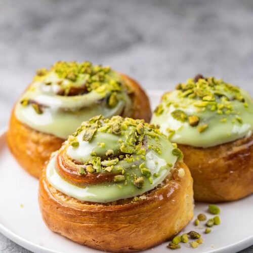 Pistachio Cinnamon Rolls with Pistachio Cream Cheese Icing are a gourmet twist on traditional cinnamon rolls, featuring a luscious pistachio filling and a creamy pistachio-infused icing. Perfect for breakfast, brunch, or a sweet snack, these rolls are sure to impress.