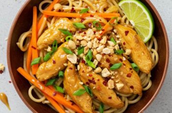 Spicy Peanut Chicken Noodles combines rice noodles and a spicy, creamy peanut sauce with tender ground chicken and fresh vegetables.