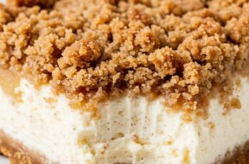 A buttery cookie crust layered with creamy apple-cinnamon cheesecake and topped with a golden, spiced crumble for the ultimate fall dessert. It’s perfect for cozy gatherings and holiday dinners.