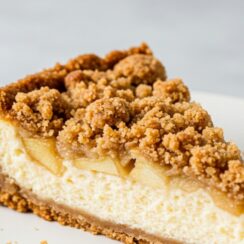 A buttery cookie crust layered with creamy apple-cinnamon cheesecake and topped with a golden, spiced crumble for the ultimate fall dessert. It’s perfect for cozy gatherings and holiday dinners.